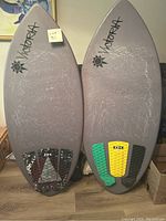 Front view of two skim boards side by side showing overall shape and size difference