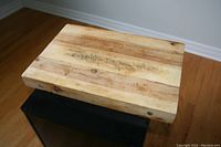 Top view of the wooden cutting board showing knife marks and natural wood grain.