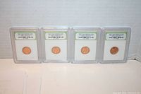 Four slabbed 1959-D Lincoln Memorial Cents in protective holders with visible labels confirming brilliant uncirculated condition.