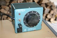 Front view showing variable output dial from 0 to 140 volts, toggle switch, power outlet, indicator light, and Staco label.