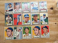 Top view of 15 assorted 1952 Topps baseball cards with some edge wear and discoloration.