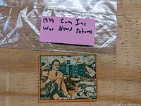 Plastic bag with pink label reading '1939 War News Pictures' above the card.