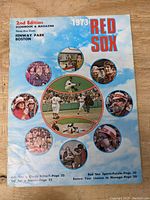Cover of the 1973 Boston Red Sox 2nd Edition Scorebook & Magazine showing colorful baseball imagery and Fenway Park mention.