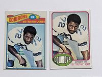 Front view of two Ed "Too Tall" Jones football cards from 1976 and 1977 showing player image and team logo.
