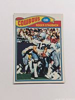 Front side of the 1977 Topps Roger Staubach football card showing player in action with Dallas Cowboys uniform.