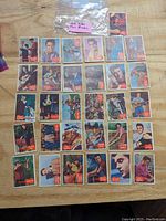 Display of 31 Elvis Presley trading cards laid out in rows showing various poses and images of Elvis Presley from 1956 Topps series.