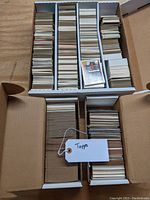 Wide view of multiple boxes filled with vintage Topps baseball cards from 1970s to 1990s.