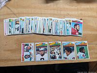 Wide view of over 60 1977 Topps football cards laid out showing multiple players and teams in a spread view.