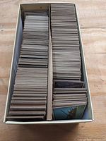 Long cardboard storage box filled with two rows of trading cards