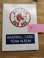 Showcase of the white plastic Boston Red Sox team album with team logo on the front cover