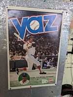 Color action photo of Carl Yastrzemski batting with a large "yaz" logo at top and crowd in background.