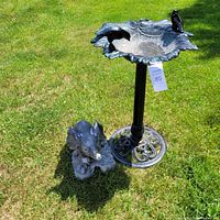 Full view of bird feeder and elephant statue on the grass showing overall condition and size