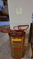 Copper fire extinguisher with red handle and hose, Guardian FIRE branding in red and gold, used for Class A fires, approx 26 inches tall.