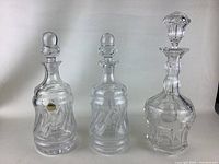 Group photo of the 3 crystal decanters showing their shapes and stoppers