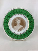 Front of the plate showing the full Queen Elizabeth II portrait and green gold border.