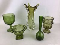 Group shot of all five green glass pieces displayed side by side