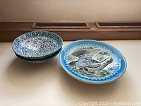 Three ceramic platters displayed side by side showing their size, shape, and designs.