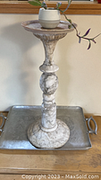 Marble plant stand approximately two feet tall displayed on a surface with a small potted plant on top.