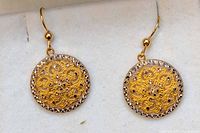 Front view of pair showing yellow gold filigree discs with white gold border