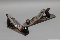 Wide angle photo of both Stanley Handyman and Footprint planes showing their overall form and condition