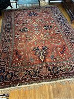 Full view of the rug on hardwood floor showing overall pattern and colors