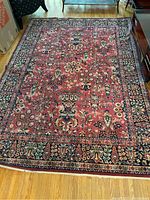 Full view of rectangular oriental area rug laid on hardwood floor