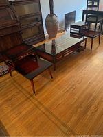 Front view of coffee table and both end tables on hardwood floor