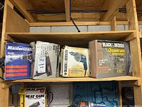 Four boxed corded drills on wooden shelf including Mastercraft and Black & Decker Quantum boxes