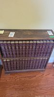 Two shelf unit containing volumes 1-50 of the 1949 Encyclopedia Britannica set, displayed spine out showing titles and volume numbers.