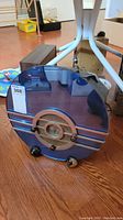Front view of purple translucent radio with metal trim and central dial