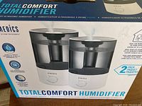 Boxed Homedics Total Comfort 2-Pack Ultrasonic Humidifiers showing image and key product features.