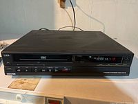 Front view of Sears VHS VCR player showing buttons and VHS slot
