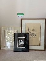 Three framed prints shown together leaning against wall