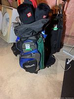 Full view of Wilson golf bag with clubs and covers inside, showing the zip compartments and exterior