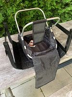 Photo of black gardening basket with metal handles and fabric covering