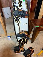 O'Brien snowboard with attached bindings showing flame and number 31 graphics