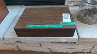 Closed wooden box containing Viking steel plate cutlery set with labels.