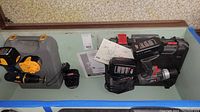Entire lot showing Porter-Cable and Ryobi drills with respective batteries, chargers, cases, and manuals