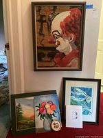 Full view of all artworks including the hand-painted circus clown portrait, framed landscape, flowers painting, pressed flowers, pencil sketch, and abstract print.