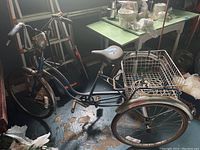Side view of entire blue Schwinn tricycle including seat, rear basket and wheels