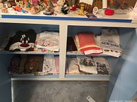 Folded shirts with cartoon and animal prints on shelves