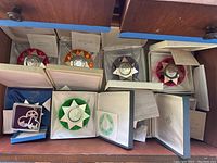 11 ornaments in original boxes within drawer: ten Franklin Mint ornaments with colored star backings and one Lunt ornament