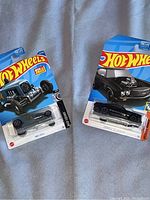 Two Hot Wheels cars in original packaging including a black Max Steel hot rod and black Chevelle SS Express with supercharger engine.