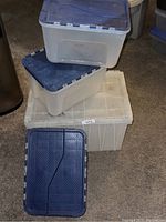 Four stacked plastic storage containers showing sizes and lid types