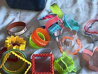 Multiple colorful cookie cutters arranged showing various shapes and sizes