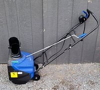 Side view of the full snow blower showing handle, wheels, chute, and Snow Joe branding