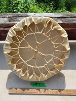 Back view showing sinew lacing and wooden frame