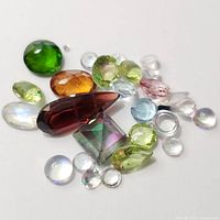 Close-up photo of assorted faceted gemstones showing different colors and shapes.