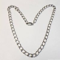Full view of the 20" sterling silver Figaro chain necklace laid out flat on white background.