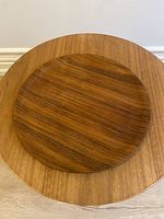 Top view of round teak tray showing wood grain and shape.